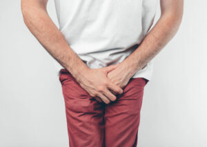 A cropped shot of a man squeezing his legs together because of urinary incontinence