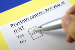 Person looks at a form that asks whether the patient has an increased risk for prostate cancer.